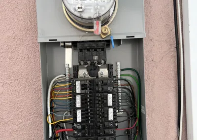 A meter box with wires attached to it.