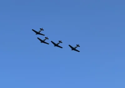 A group of planes flying in a blue sky.