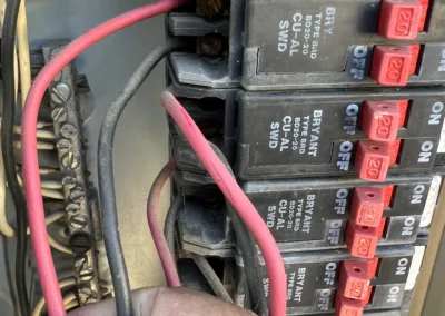 A hand holding a wire.