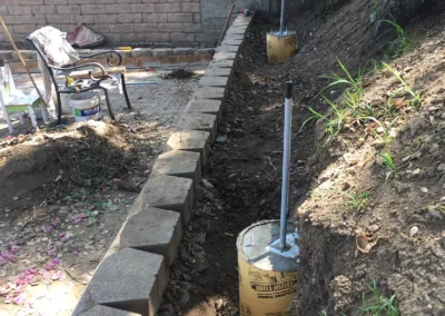 A retaining wall is being built in a backyard.