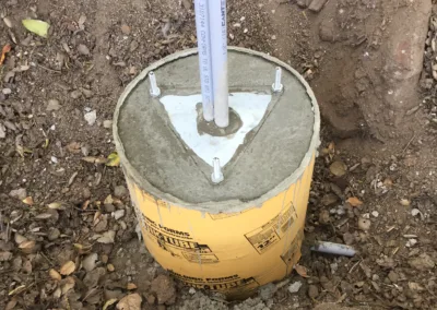 A concrete pole in the ground.