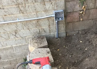 A drill is being used to drill into a brick wall.