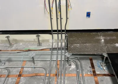 A room with wires and pipes on the floor.