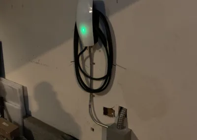 A wall mounted ev charger in a garage.